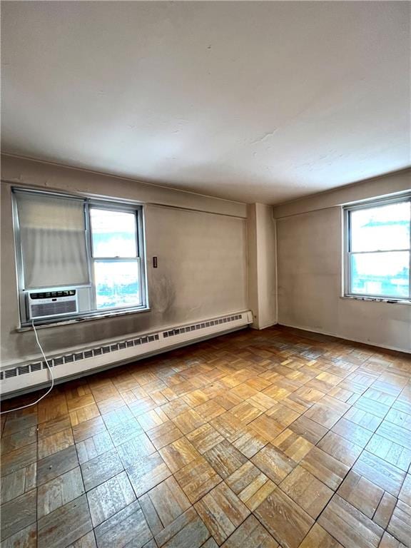 empty room with a baseboard heating unit and cooling unit