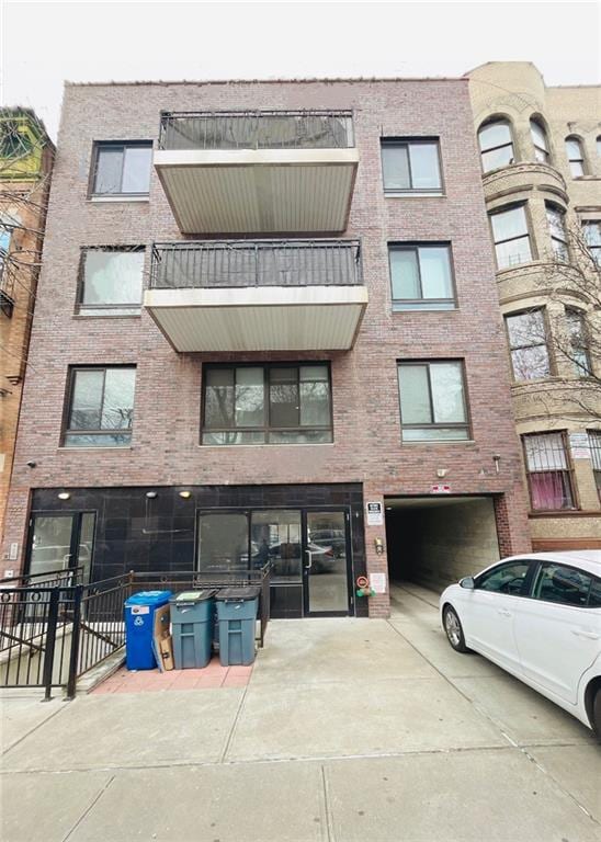 229 55th St Unit 5, Brooklyn, NY 11220 - view of apartment building / complex with driveway and a garage