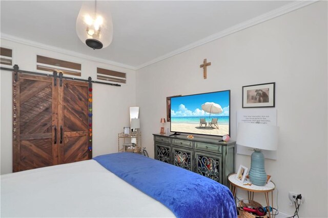 bedroom featuring ornamental molding and a barn door