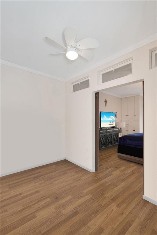 unfurnished room with crown molding, ceiling fan, and hardwood / wood-style flooring