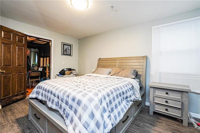 bedroom with dark hardwood / wood-style flooring