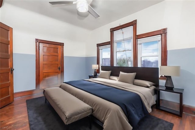 bedroom with dark wood-type flooring and ceiling fan