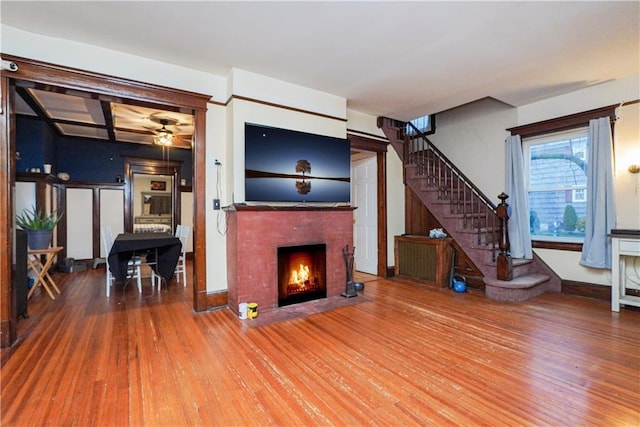 202 Watchogue Rd, Staten Island, NY 10314 - unfurnished living room featuring a fireplace, wood finished floors, a ceiling fan, and stairway