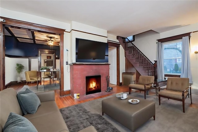 living room featuring ceiling fan and light wood-type flooring