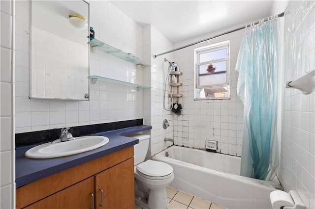 full bathroom with vanity, backsplash, tile patterned floors, toilet, and tile walls