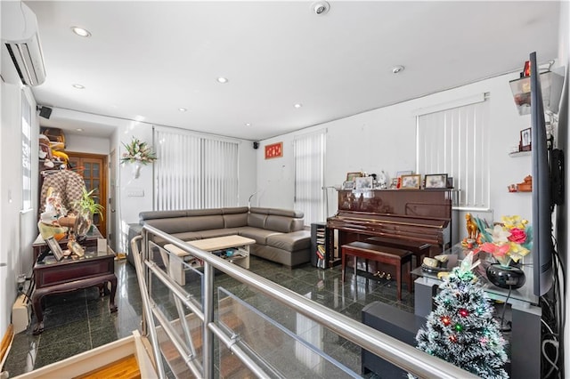 living room with hardwood / wood-style flooring and a wall unit AC