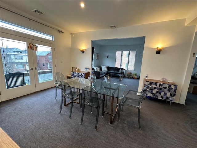 dining area with dark colored carpet and french doors