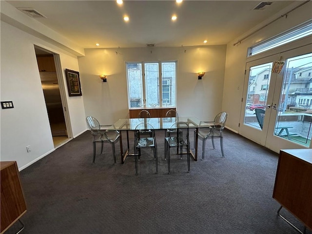 carpeted dining area featuring french doors