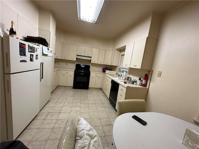 kitchen with black appliances and white cabinets