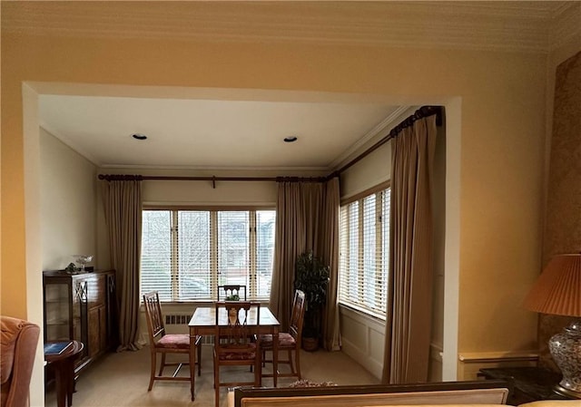 dining area featuring light colored carpet and crown molding