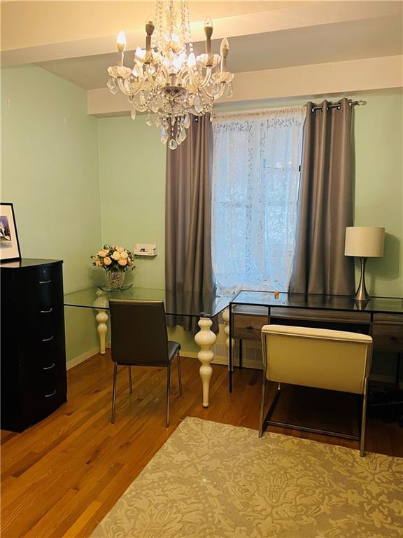 sitting room featuring hardwood / wood-style flooring and a notable chandelier