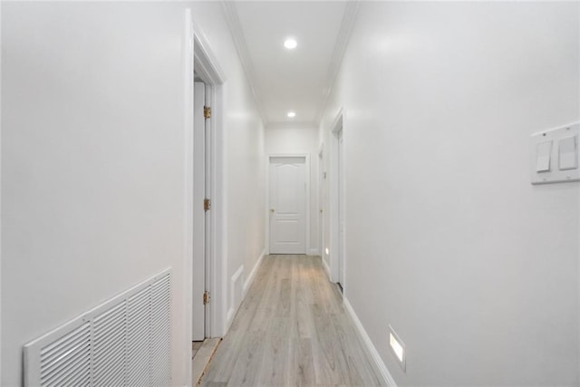 hall featuring ornamental molding and light wood-type flooring