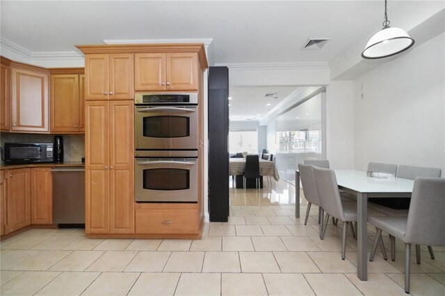 kitchen featuring light tile patterned flooring, pendant lighting, decorative backsplash, ornamental molding, and stainless steel double oven