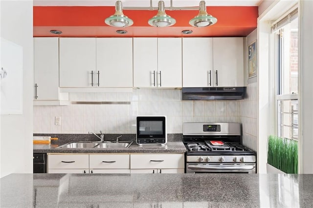 kitchen with gas stove, backsplash, sink, and white cabinets