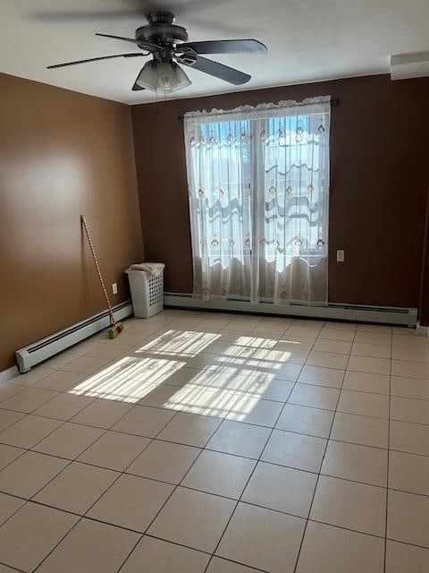 unfurnished room with baseboard heating, ceiling fan, and light tile patterned floors