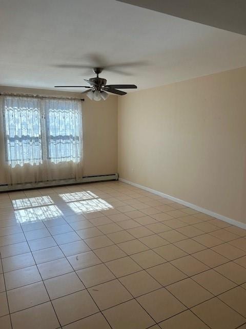 tiled empty room with baseboard heating and ceiling fan