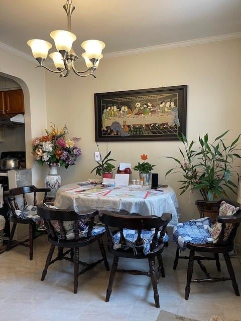 dining room with arched walkways, a chandelier, and crown molding