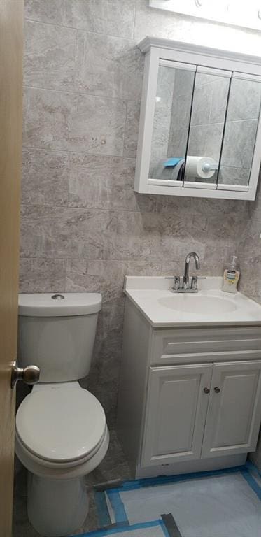 bathroom featuring toilet and vanity