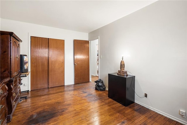 bedroom featuring a closet and dark hardwood / wood-style floors