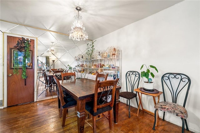 dining area with a notable chandelier and hardwood / wood-style floors