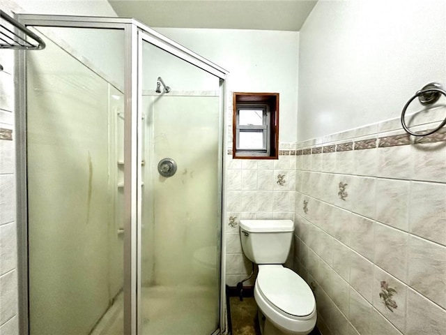 bathroom with an enclosed shower, tile walls, and toilet