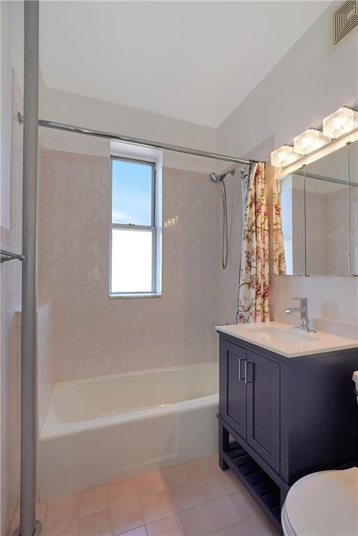 full bathroom featuring tile patterned flooring, vanity, shower / tub combo, and toilet