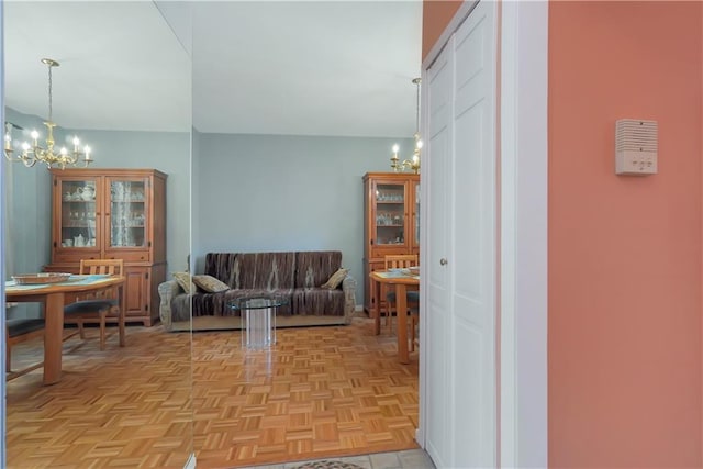 interior space featuring light parquet floors and an inviting chandelier