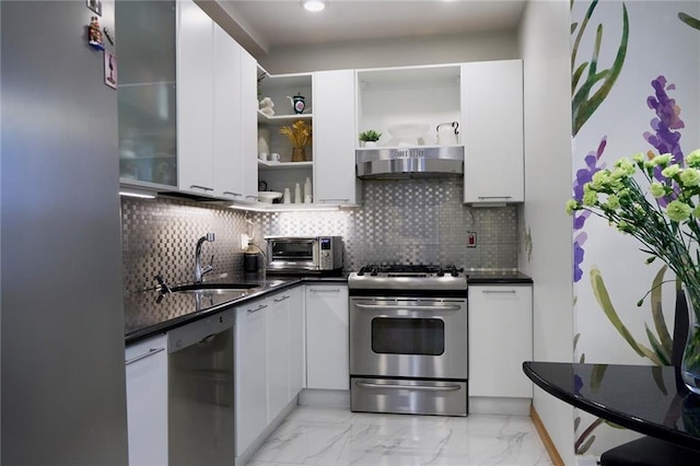 kitchen with white cabinetry, stainless steel appliances, decorative backsplash, and sink