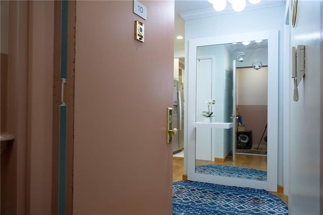 corridor with crown molding and wood-type flooring