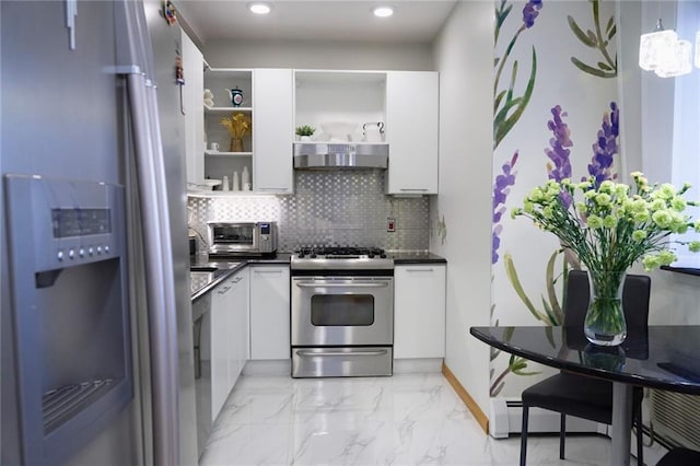 kitchen with appliances with stainless steel finishes, decorative backsplash, white cabinetry, and decorative light fixtures