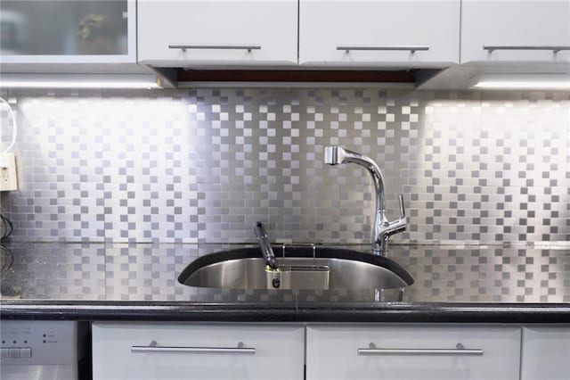 kitchen featuring decorative backsplash and white cabinetry