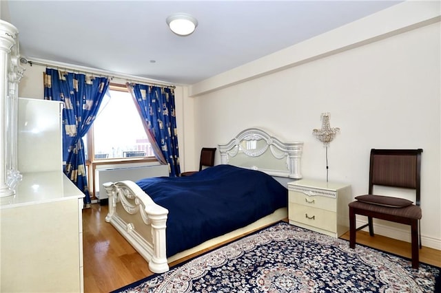 bedroom featuring dark hardwood / wood-style flooring