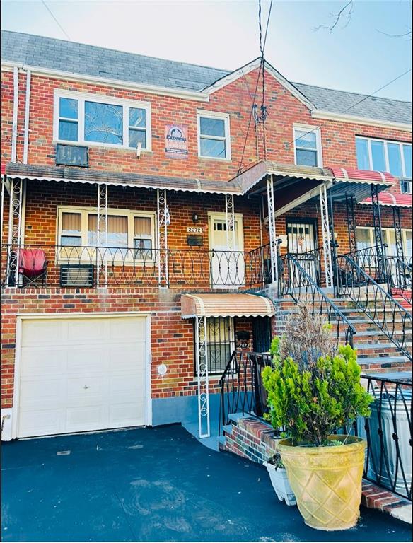 view of property featuring a garage and covered porch