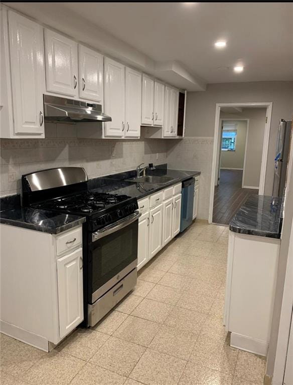 kitchen featuring white cabinetry, sink, backsplash, and appliances with stainless steel finishes