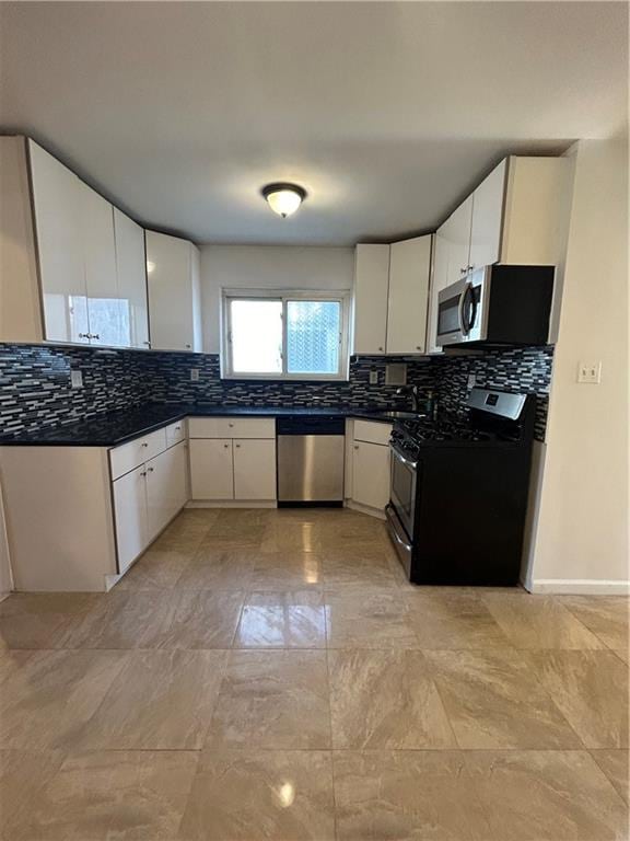 kitchen featuring backsplash, appliances with stainless steel finishes, and white cabinets