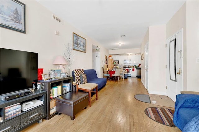 living room with light hardwood / wood-style flooring