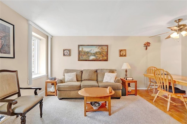 living room with ceiling fan and light parquet flooring