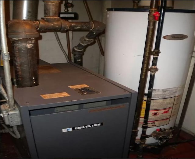 utility room featuring gas water heater