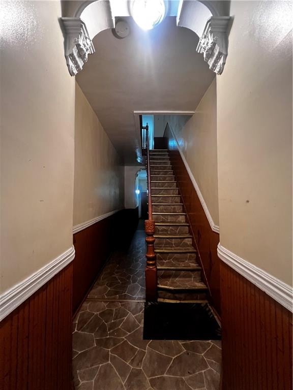 staircase featuring dark tile patterned floors