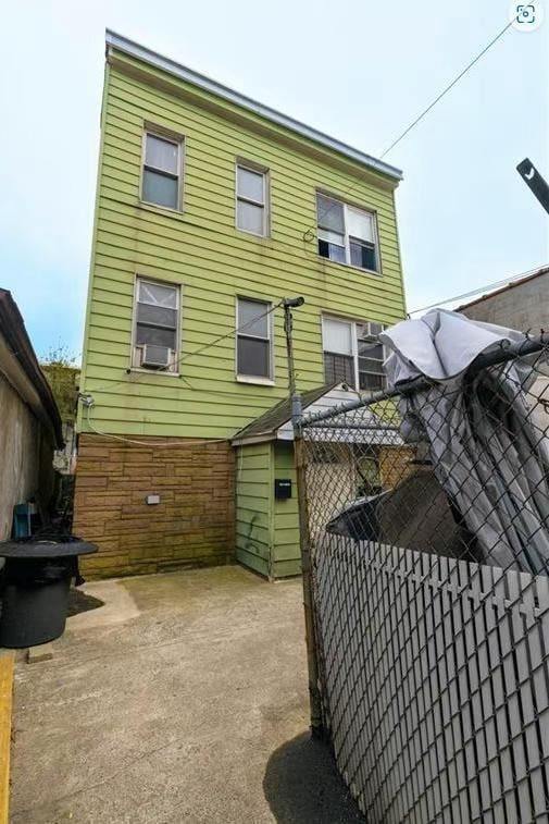 rear view of house with cooling unit