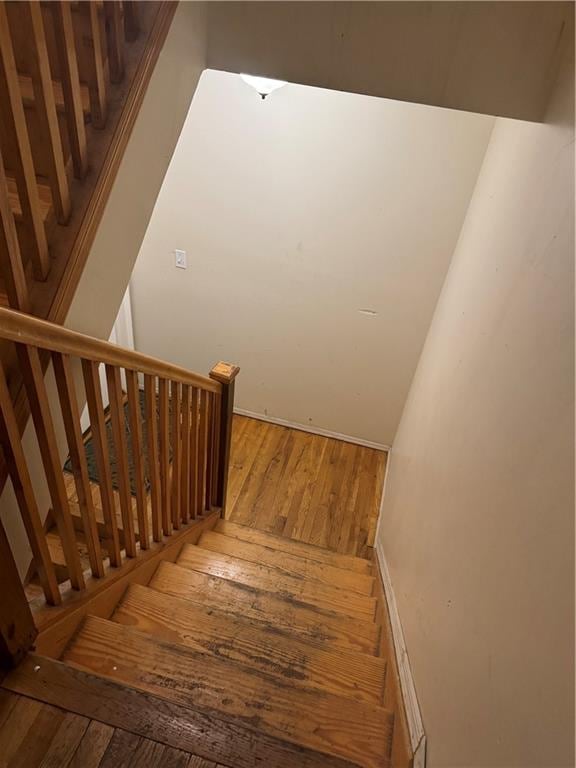 stairs with hardwood / wood-style floors