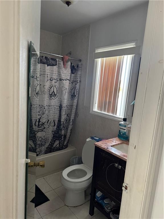 full bathroom featuring tile patterned flooring, vanity, toilet, and shower / bathtub combination with curtain