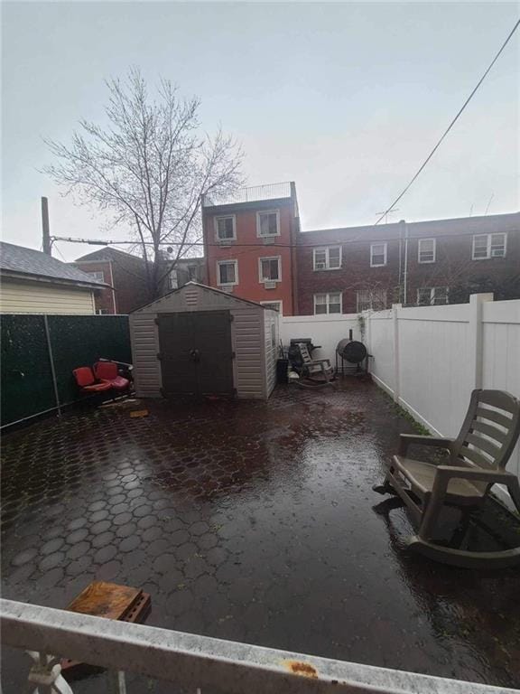 view of patio featuring a storage unit and grilling area