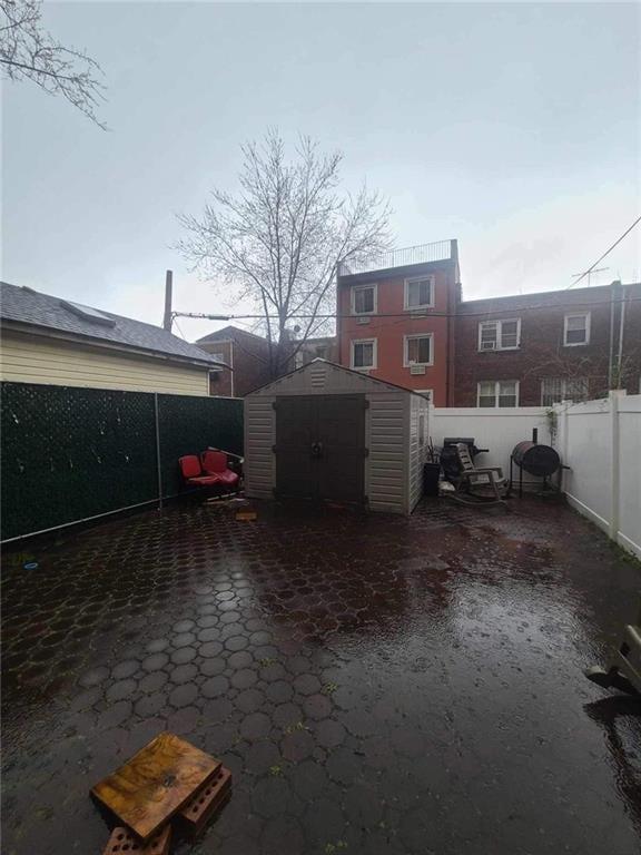 view of patio featuring a storage unit