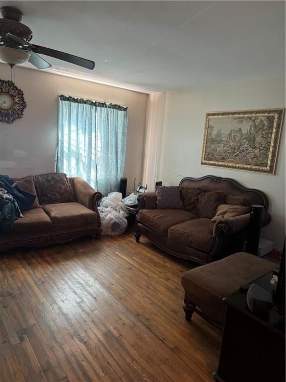 living room featuring ceiling fan and dark wood-type flooring