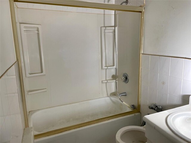 full bathroom with vanity, tile walls, shower / bathtub combination, and toilet