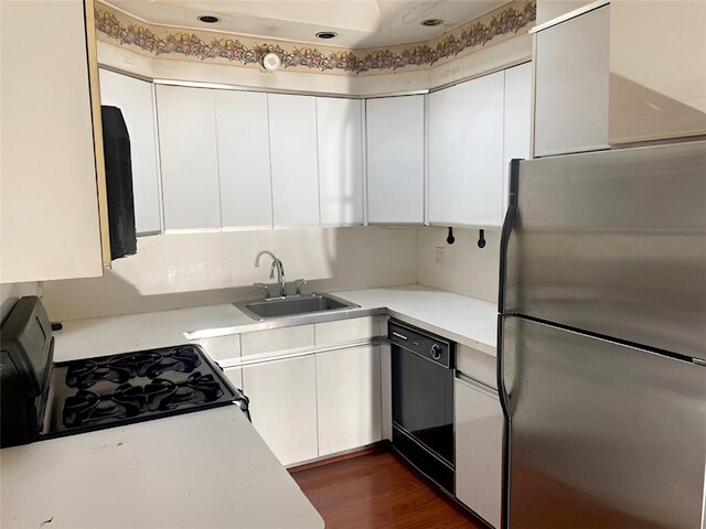 kitchen featuring white cabinetry, dark hardwood / wood-style flooring, sink, and black appliances