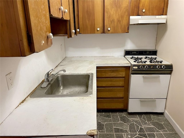 kitchen with white range oven, sink, and range hood