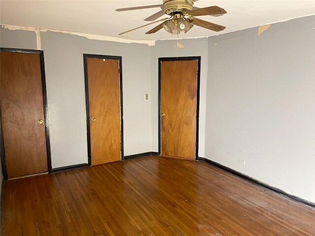 unfurnished bedroom with dark hardwood / wood-style floors and ceiling fan