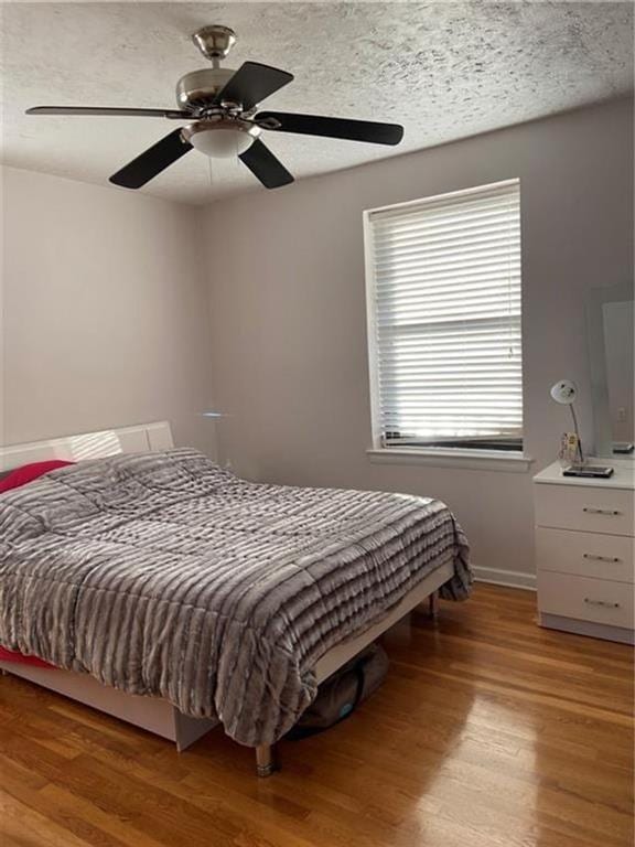 bedroom featuring ceiling fan and light hardwood / wood-style flooring